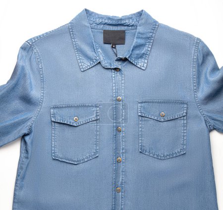 Modern, casual and comfortable blue denim shirt with relaxed fit, detailed stitching and practical front pockets, presented isolated on white backdrop