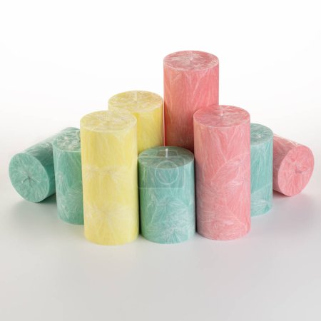 Collection of handcrafted pink and green palm wax candles of different sizes, ideal for adding warmth and comfort to everyday life, arranged against white backdrop