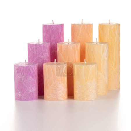 Photo for Collection of handcrafted pink and green palm wax candles of different sizes, ideal for adding warmth and comfort to everyday life, arranged against white backdrop - Royalty Free Image