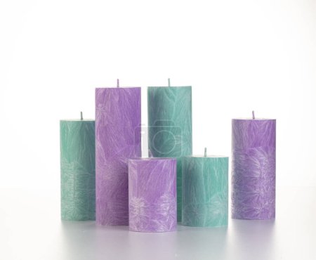 Collection of handcrafted pink and green palm wax candles of different sizes, ideal for adding warmth and comfort to everyday life, arranged against white backdrop