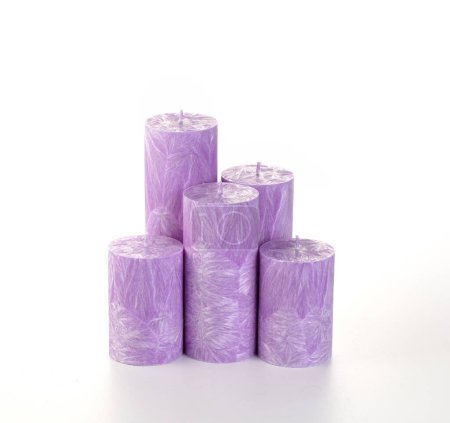 Photo for Exquisite collection of aromatic yellow and purple palm wax candles with unique icicle texture, designed to infuse space with color and relaxing fragrance, on white. Handcrafted interior accessories - Royalty Free Image