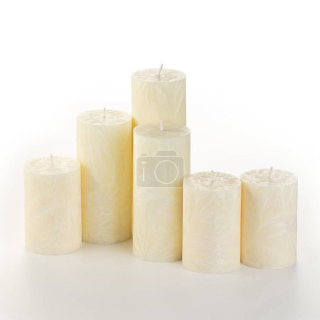 Photo for Natural yellow palm wax pillar candles of varying heights; featuring unique ice pattern texture grouped on white background. Handmade accessories for refreshing interior decor - Royalty Free Image