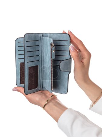 Female hands holding open blue leather wallet with multiple slots for cards, zipper compartments for cash and coins against white background. Stylish and convenient women accessor