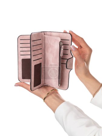 Female hands holding open pitch leather wallet with multiple slots for cards, zipper compartments for cash and coins against white background. Stylish and convenient women accessor