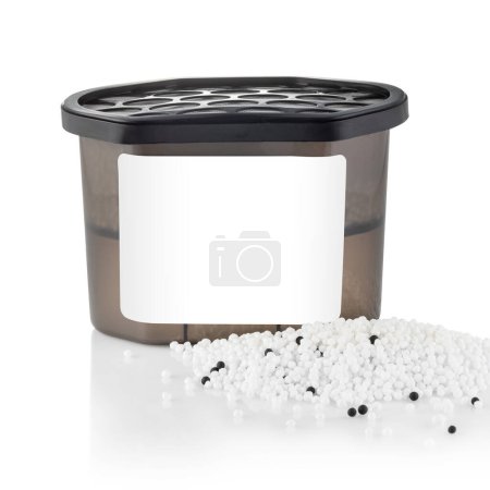 Photo for Empty moisture absorber with perforated black  lid and pile of white absorbent granules in front of container. Concept of functional home goods item designed to create comfortable living climate - Royalty Free Image