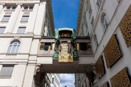 Photo for VIENNA, AUSTRIA - APRIL 16, 2023: Art Nouveau anchor clock between houses above the street on the Hoher Markt in Vienna - Royalty Free Image
