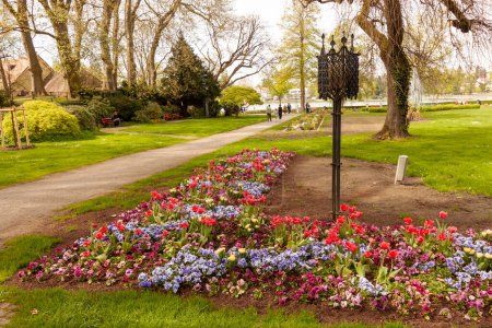 Photo for LINDAU; GERMANY - APRIL 13, 2024: A bright colorful flower bed in the park in Lindau, Germany - Royalty Free Image