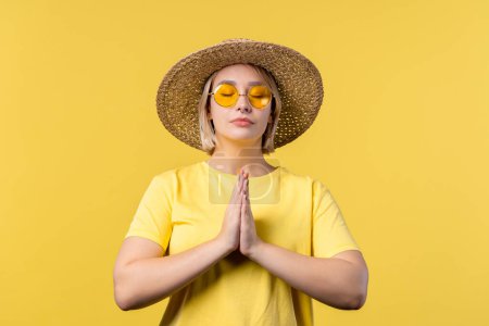 Photo for Summer woman praying for peace, love, harmony on yellow background. Girl begs God to save people, children. Gratitude, religion concept. High quality photo - Royalty Free Image