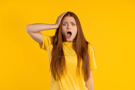 Photo for Worried confused woman, no, she forgot. Shocked girl feeling sorrow, regret, drama, failure, problems on yellow background. High quality photo - Royalty Free Image