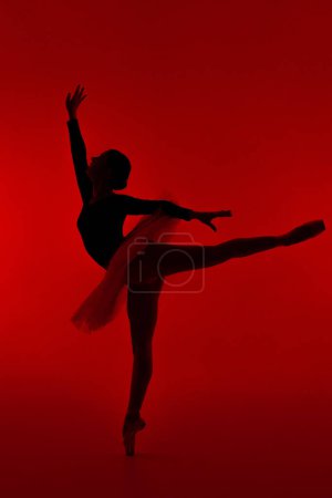 Photo for Beautiful ballerina on red background dancing ballet. Woman performs smooth movements. Sensual dancer in tutu dress on scene under neon light. High quality photo - Royalty Free Image