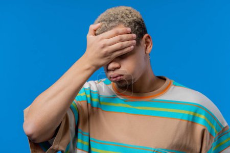 Photo for Worried sad man, no, he forgot. Disappointed guy feeling sorrow, regret, drama, failure, problems on blue background. High quality photo - Royalty Free Image