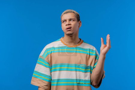 Photo for Irritated american man showing bla-bla-bla gesture with hands, rolling eyes on blue background. Empty promises, blah concept. Lier. High quality photo - Royalty Free Image