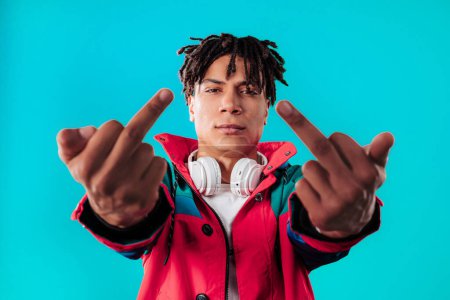 Photo for Young handsome african man on dark background showing middle finger - gesture of fuck. Expression negative, aggression, provocation. - Royalty Free Image