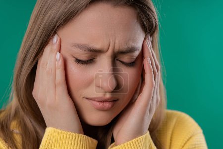 Photo for Portrait of beautiful suffering woman having headache, studio portrait. Girl putting hands on head. Concept of migraine problems, medicine, illness, magnetic storms concept - Royalty Free Image