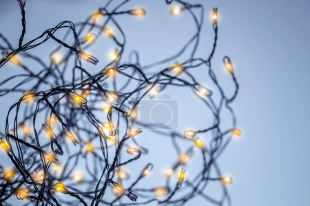 Photo for Christmas Mood. Glowing Festoon with Mild Golden Lights as Christmas Background. New Year Party. Modern Holiday Background - Royalty Free Image