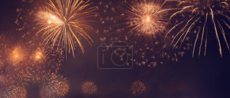 Photo for Beautiful New Year Holidays Background. Wonderful Golden Salute Over Dark Night Sky. Happy Christmas Time with Fireworks. Abstract Golden Lights - Royalty Free Image