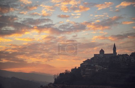 Téléchargez les photos : Silhouette of a Church on the Hill. Mountainous Town over Beautiful Sunset Sky Background. Peaceful Panoramic View. Gorgeous Beauty of Lebanon - en image libre de droit