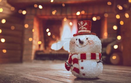 Foto de Christmas Home Decor. Winter House Decorated with Festoon. Little Decorate Snowman over Fireplace Background. Stylish Festive Bauble. - Imagen libre de derechos