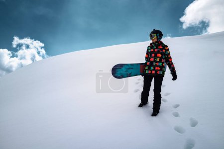 Photo for Active people enjoying the snow. Sports life and leisure. Snowboarder tourist girl walking on the mountain top. Ski park resort. Winter holidays and seasonal vacation travel. - Royalty Free Image
