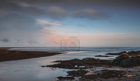 Photo for Peaceful winter landscape, amazing panoramic view on the water and majestic mountains behind it, extreme travel. Iceland roadtrip. - Royalty Free Image