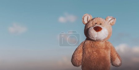 Photo for Babyish background. Playtime concept. Soft toy Bear over sly pastel sky. Nursery theme. - Royalty Free Image