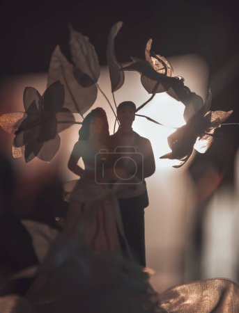 Photo for Photo of a Tasty Wedding Cake with Traditional Wedding Toys on Top. Ceremony Outdoors. Bride and Groom Dolls. New Family Concept. - Royalty Free Image