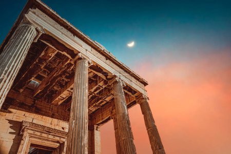 Photo for Gorgeous majestic ancient temple ruins over colorful sky background with a moon on a side. Famous touristic place. Parthenon. Athens. Greece. Europe. - Royalty Free Image