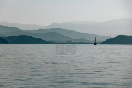 Photo for Photo of mountains and the sea landscape. Overcast weather. Travel by sailboat. Summer vacation in the sea. Turkey - Royalty Free Image