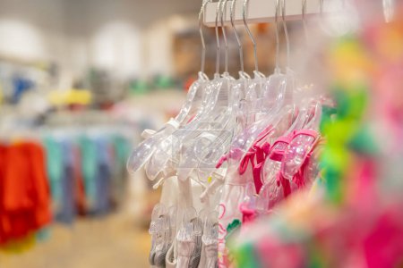 Photo for Closeup photo of a many hangers with colorful clothes in the shop. New spring-summer collection. Retail store. Shopping therapy. - Royalty Free Image