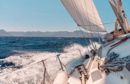 Téléchargez les photos : Photo d'un voilier dans la mer par une journée ensoleillée. Voyage à la voile. Sport nautique. Vacances d'été de luxe sur le yacht. - en image libre de droit