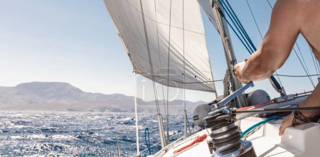 Photo for Experienced sailor working on sailboat. Enjoying travel along the sea. Yachting sport. Summer holidays. Luxury vacation on water transport. - Royalty Free Image