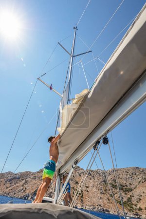 Photo for Crew Working on Sailboat. Beautiful Sunny Day. Friends Enjoying Travel along Sea. Yachting Sport. Summer Holidays. - Royalty Free Image