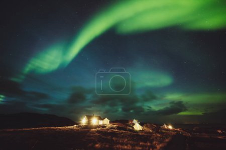 Photo for Amazing view of a beautiful aurora borealis dancing in the sky. Majestic northern light at night. Travel to Norway. The beauty of wild nature. - Royalty Free Image