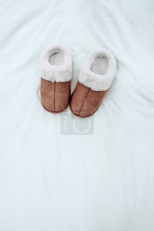 Old-fashioned warm brown winter shoes with white fur turned outwards, which makes them unique and authentic. Isolated on clean background.