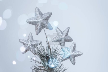 Photo for Closeup photo of a beautiful festive Christmastime interior decoration. Silver stars as a symbol of Xmas traditions. Magical time on Christmas Eve. - Royalty Free Image