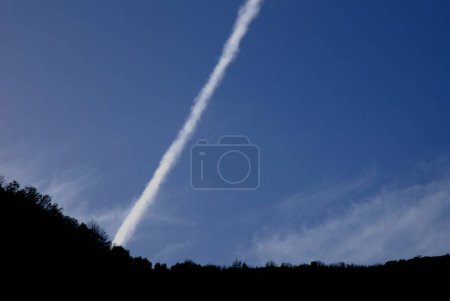 Téléchargez les photos : Les traînées de contractions sont des nuages en forme de ligne produits par les gaz d'échappement des moteurs d'avions, Italie du Sud, 27 mars 2024. - en image libre de droit