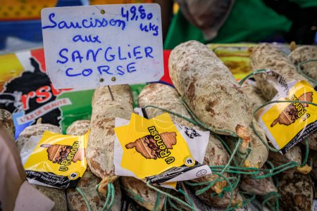 Foto de Antibes, Francia - 24 de mayo de 2023: Salchicha de jabalí de Córcega a la venta en un stand en un mercado local cubierto de agricultores provenzales en el casco antiguo - Imagen libre de derechos