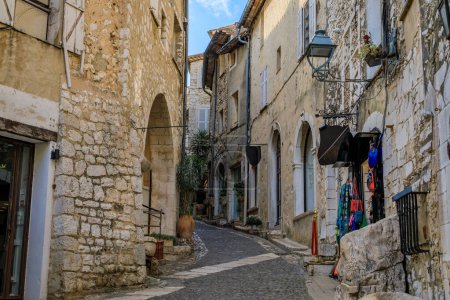Photo for Traditional old stone houses with gift shops on a street in the medieval town of Saint Paul de Vence, French Riviera, South of France - Royalty Free Image