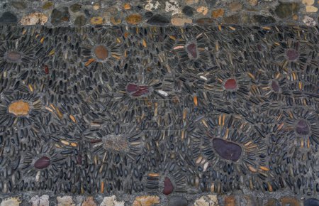 Photo for Ornate pebble mosaic street pavement between traditional houses on a street in Saint Paul de Vence medieval town, French Riviera, South of France - Royalty Free Image