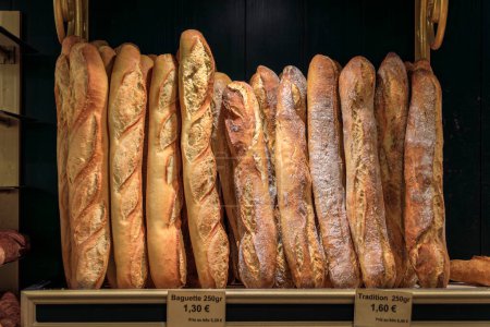 Photo for Loaves of freshly baked rustic French baguettes on display at an artisanal bakery in the old town or Vieil Antibes, South of France - Royalty Free Image