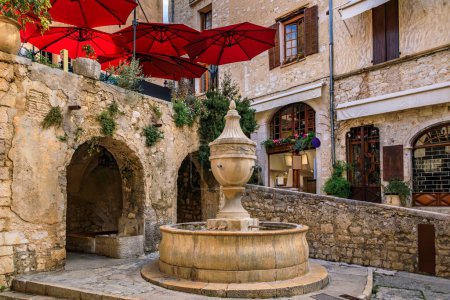 Photo for Traditional old stone fountain on a central square in the medieval town of Saint Paul de Vence, French Riviera, South of France - Royalty Free Image