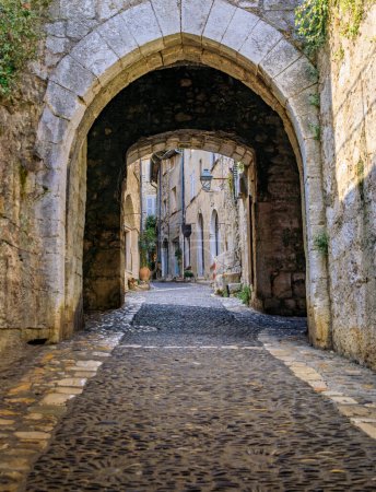 Photo for Arched passage way in the traditional medieval stone city walls of the Old Town, Vieille Ville in Saint Paul de Vence, French Riviera, South of France - Royalty Free Image