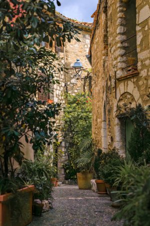 Photo for Traditional old stone houses on a street in the medieval town of Saint Paul de Vence, French Riviera, South of France - Royalty Free Image