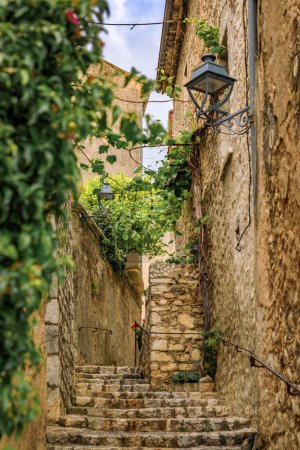 Photo for Traditional old stone houses on a street in the medieval town of Saint Paul de Vence, French Riviera, South of France - Royalty Free Image