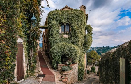 Photo for Traditional old stone house with jasmine vines where the French poet Jaques Prevert lived in the 1940s, medieval Saint Paul de Vence, South of France - Royalty Free Image