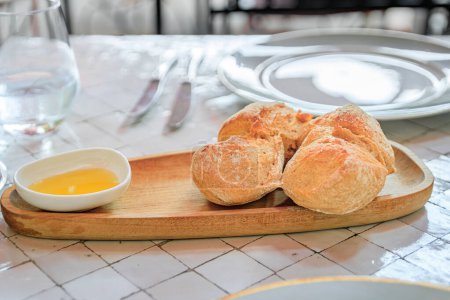 Photo for Fresh rustic bread and olive oil at an outdoor table at a restaurant in the medieval town of Saint Paul de Vence, French Riviera, South of France - Royalty Free Image