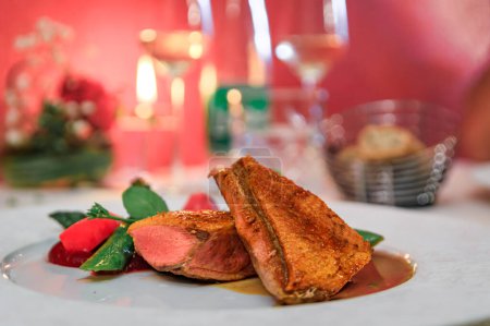 Photo for Seared rare duck breast with asparagus, pea shoots and raspberry compote at a fine dining Alsatian winstub restaurant Colmar, Alsace, France - Royalty Free Image