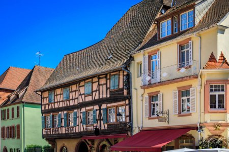 Ornate traditional half timbered houses with blooming flowers in a popular village on the Alsatian Wine Route in Kaysersberg, France