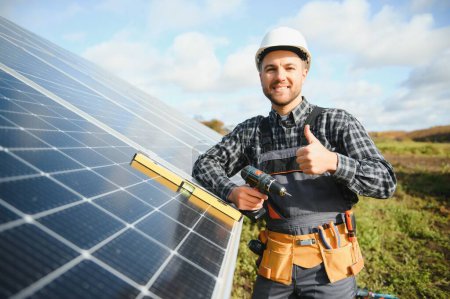 Photo for Solar power plant worker checks the condition of the panels. - Royalty Free Image