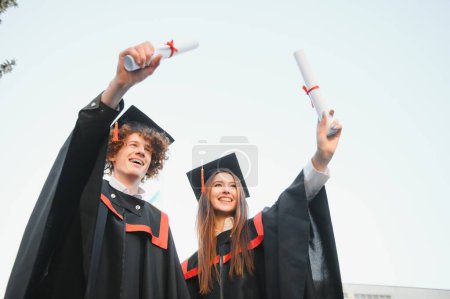 Photo for Portrait of two happy graduating students - Royalty Free Image